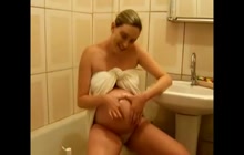 Pregnant slut oils up her belly