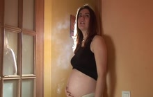 Pregnant girl smoking a cigar
